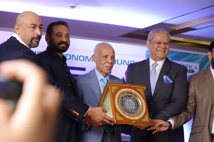 PAC leadership presenting a souvenir shield to an honored guest